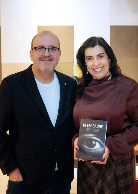 AI in Healthcare book signing night — reader with the book