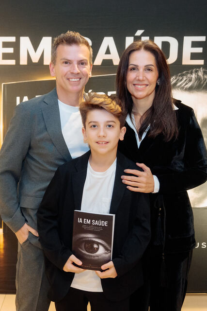 AI in Healthcare book signing night — reader with the book
