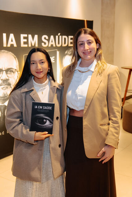 AI in Healthcare book signing night — reader with the book