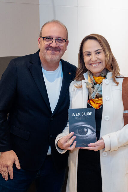 AI in Healthcare book signing night — reader with the book