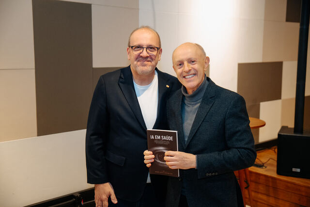 AI in Healthcare book signing night — reader with the book