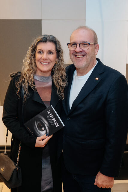AI in Healthcare book signing night — reader with the book