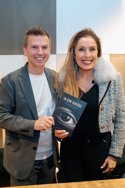 AI in Healthcare book signing night — reader with the book