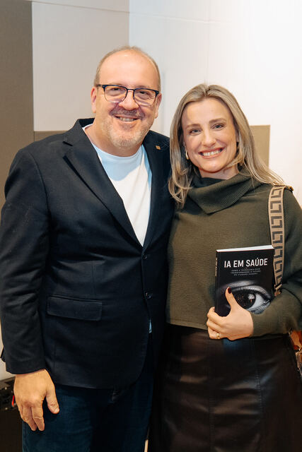 AI in Healthcare book signing night — reader with the book