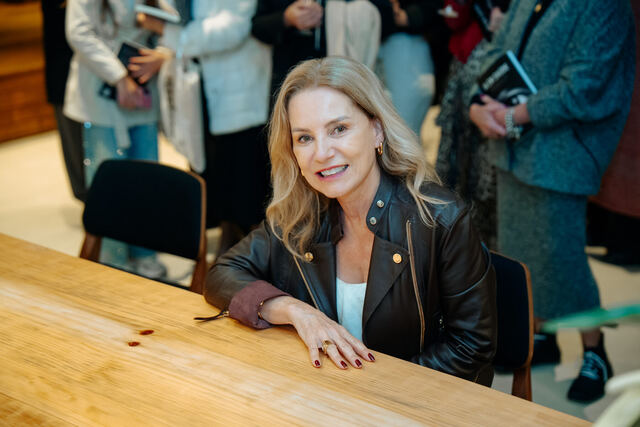 AI in Healthcare book signing night — reader with the book