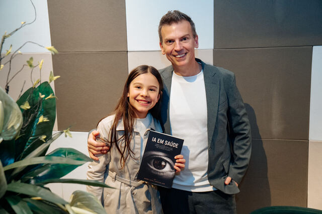 AI in Healthcare book signing night — reader with the book