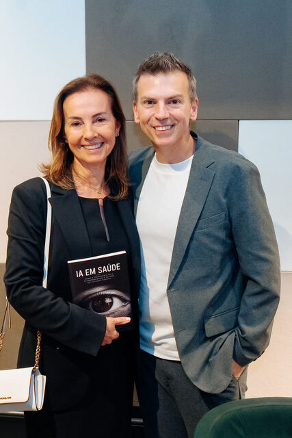 AI in Healthcare book signing night — reader with the book