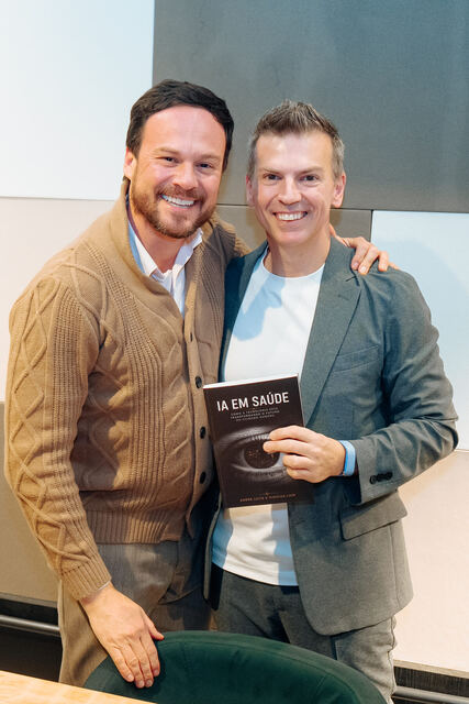 AI in Healthcare book signing night — reader with the book