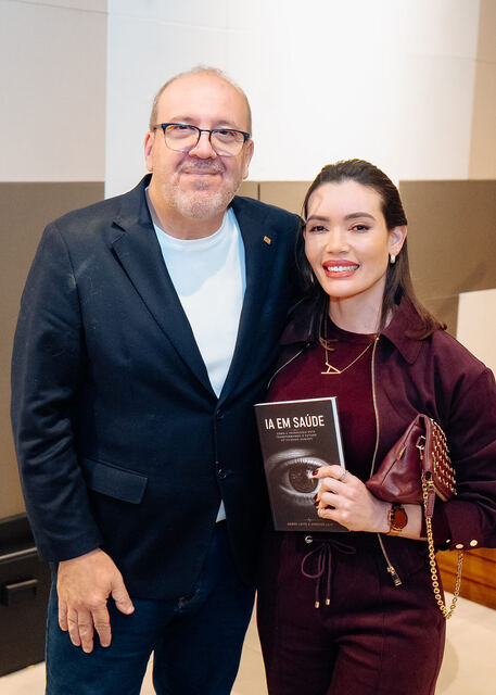AI in Healthcare book signing night — reader with the book