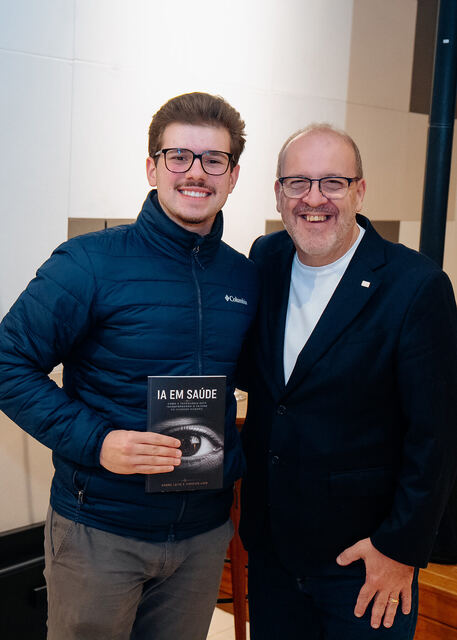 AI in Healthcare book signing night — reader with the book
