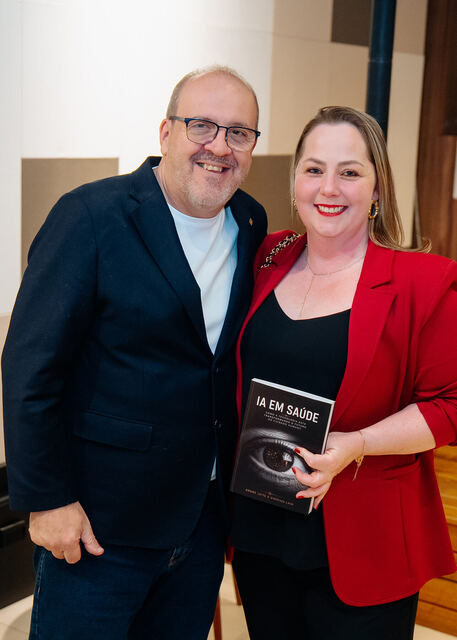 AI in Healthcare book signing night — reader with the book