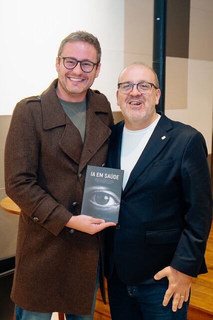 AI in Healthcare book signing night — reader with the book