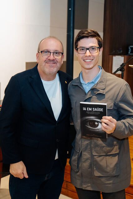 AI in Healthcare book signing night — reader with the book