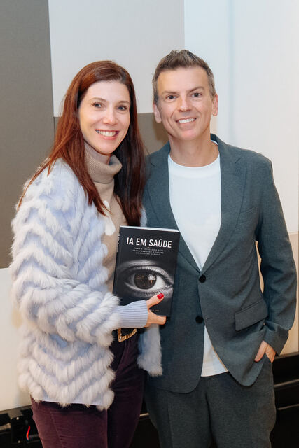 AI in Healthcare book signing night — reader with the book