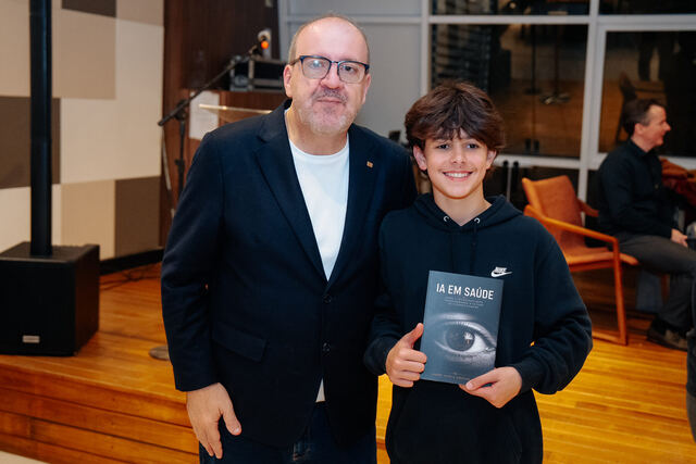 AI in Healthcare book signing night — reader with the book